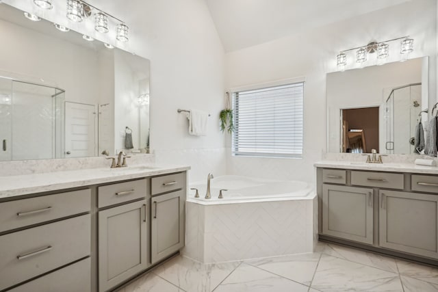 bathroom featuring vanity, lofted ceiling, and independent shower and bath