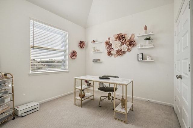 home office with light colored carpet and vaulted ceiling