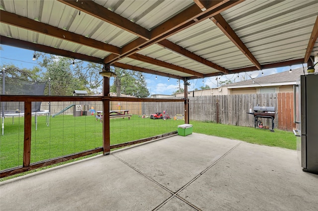 view of patio with a grill and a trampoline