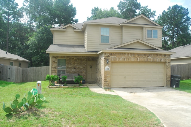 view of front of property with a front yard and a garage