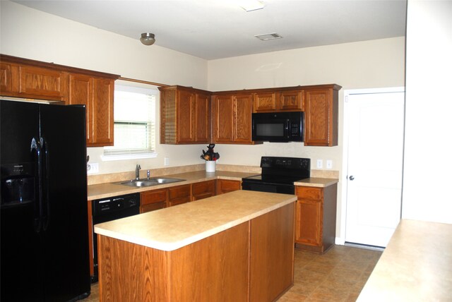 kitchen featuring sink, a center island, and black appliances