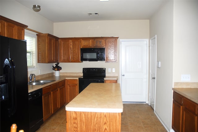 kitchen with sink, a kitchen island, and black appliances