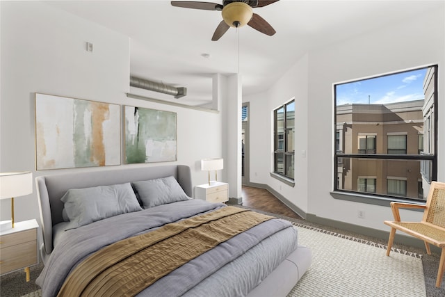 bedroom with hardwood / wood-style floors and ceiling fan