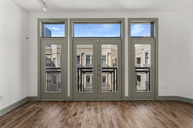 doorway featuring rail lighting and dark hardwood / wood-style floors