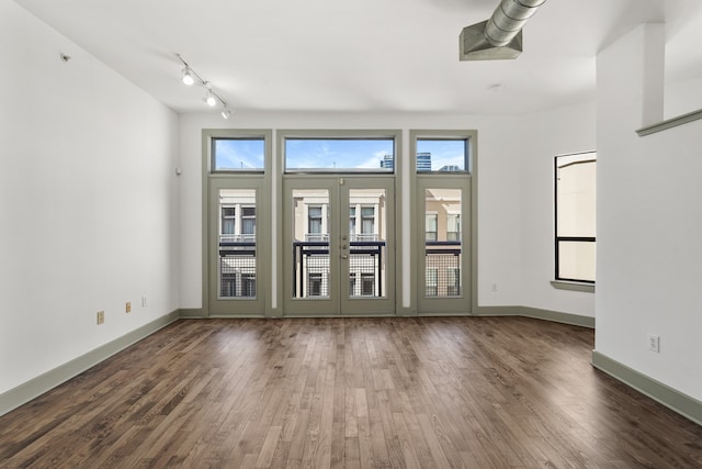 empty room featuring dark wood-type flooring and french doors