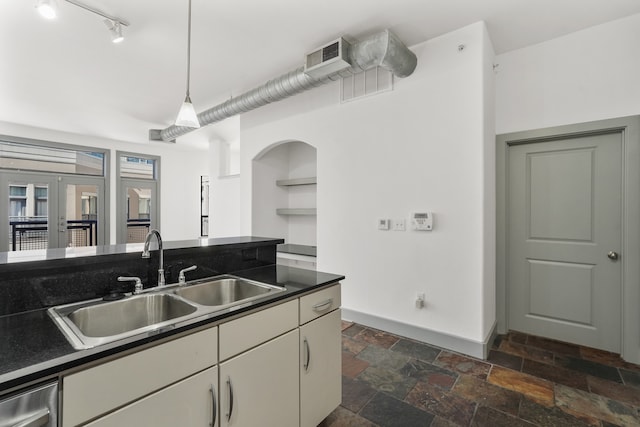 kitchen with french doors, stainless steel dishwasher, hanging light fixtures, and sink