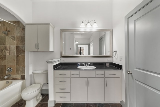 full bathroom with vanity, tiled shower / bath combo, and toilet