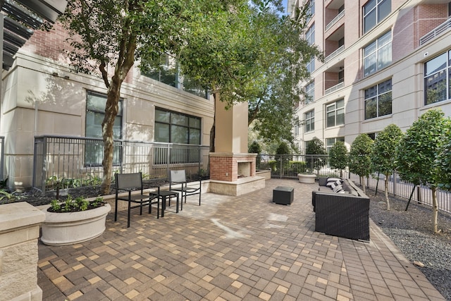 view of patio with exterior fireplace