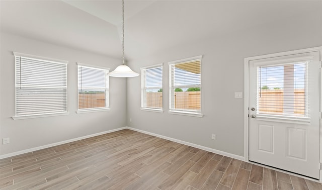 unfurnished dining area featuring light wood-type flooring and a wealth of natural light