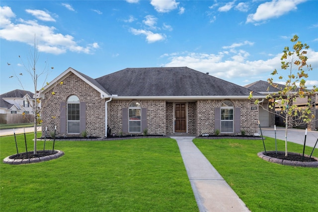 ranch-style home featuring a front lawn and a garage