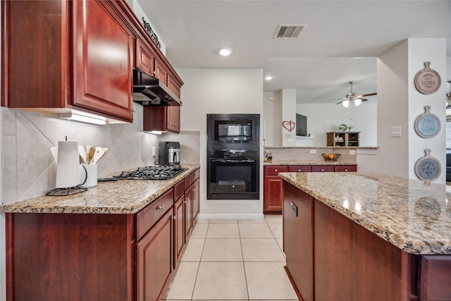 kitchen with ceiling fan, tasteful backsplash, black appliances, light stone countertops, and light tile patterned floors