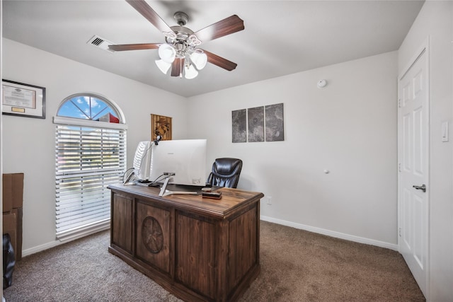 carpeted home office featuring ceiling fan