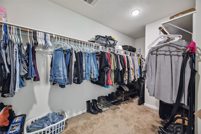 walk in closet with carpet floors