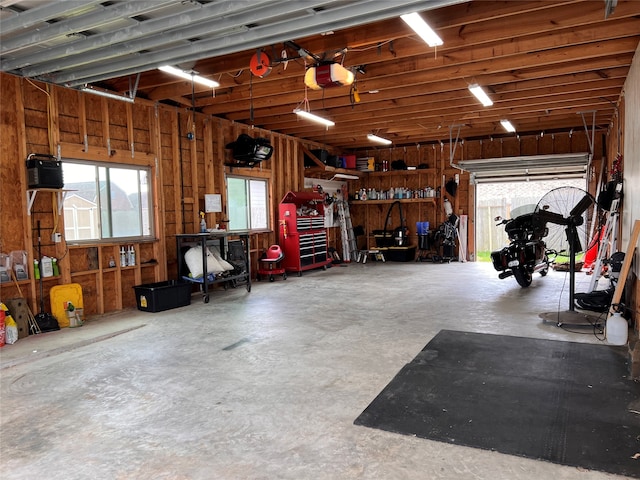 garage featuring a garage door opener and a workshop area