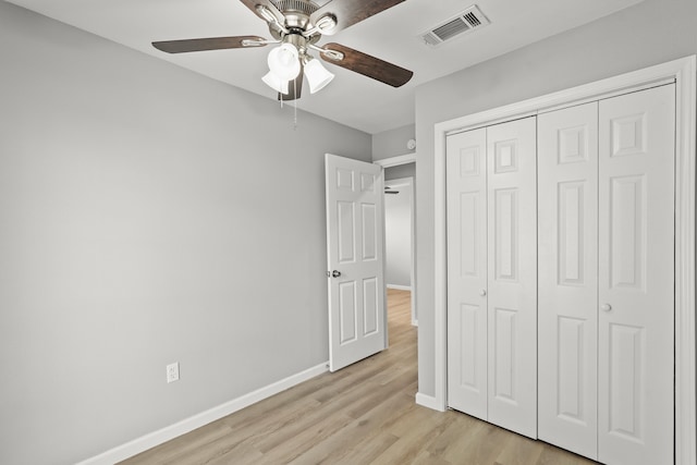 unfurnished bedroom featuring a closet, ceiling fan, and light hardwood / wood-style flooring