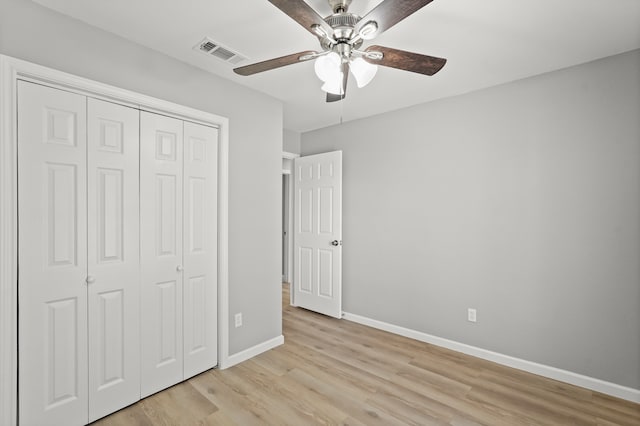 unfurnished bedroom with light wood-type flooring, a closet, and ceiling fan