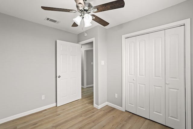 unfurnished bedroom featuring a closet, light hardwood / wood-style flooring, and ceiling fan