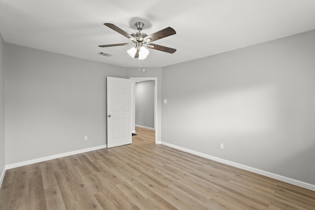 spare room with ceiling fan and light wood-type flooring