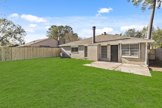 back of house featuring a lawn, a patio area, and cooling unit