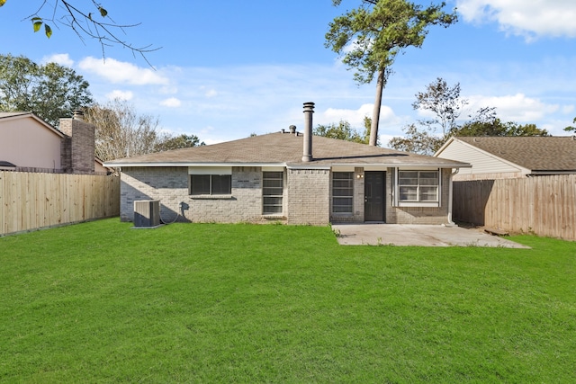 rear view of house featuring a lawn, central air condition unit, and a patio