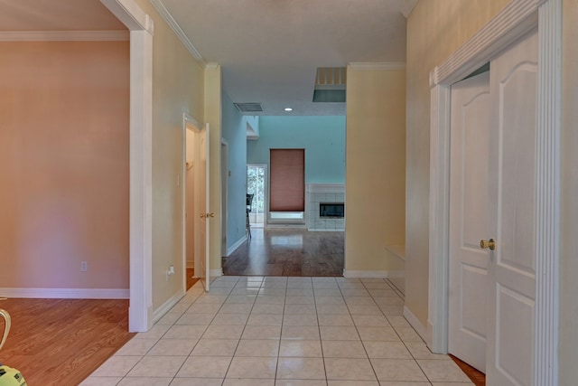 hall featuring light hardwood / wood-style flooring and ornamental molding