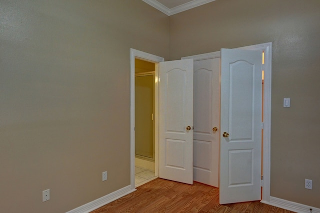 unfurnished bedroom featuring light hardwood / wood-style floors and ornamental molding