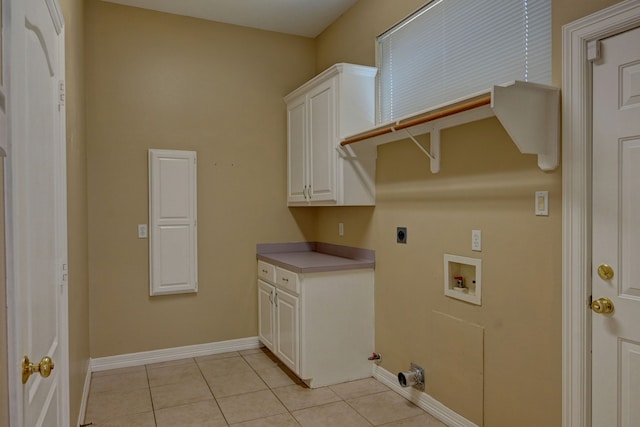 washroom featuring cabinets, hookup for a washing machine, light tile patterned floors, and electric dryer hookup