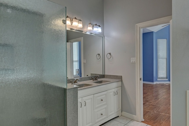 bathroom featuring a shower with door, vanity, and wood-type flooring