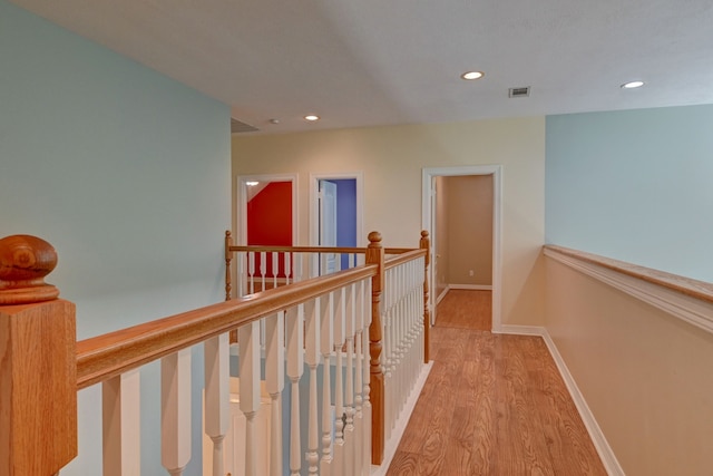 corridor with light hardwood / wood-style flooring