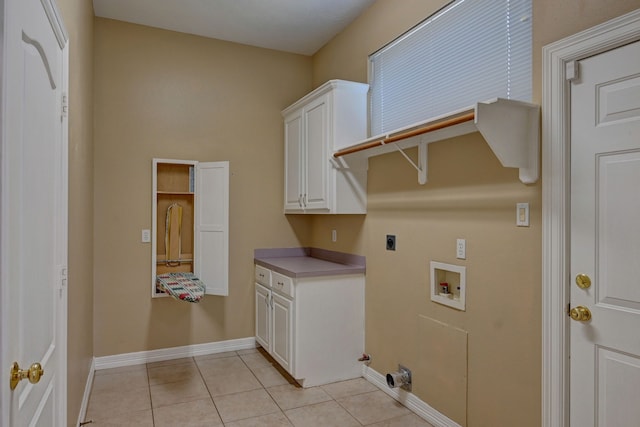 laundry area with electric dryer hookup, light tile patterned flooring, cabinets, and hookup for a washing machine