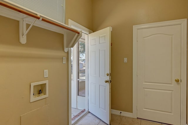 washroom featuring washer hookup and light tile patterned flooring