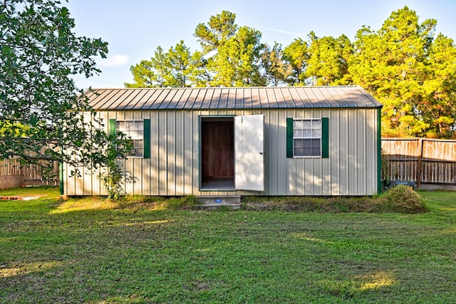 view of outbuilding with a yard