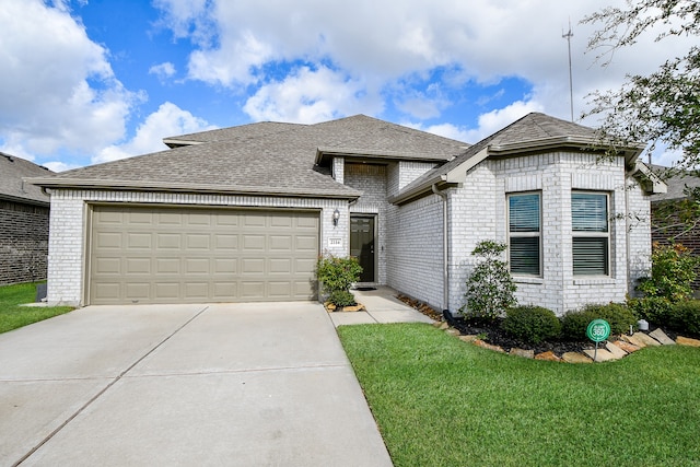 view of front of property with a garage and a front yard