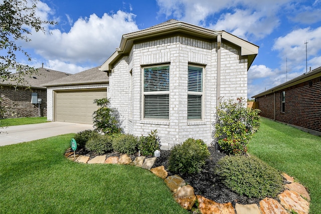 view of side of home featuring a lawn and a garage