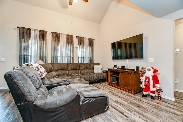 living room featuring ceiling fan, wood-type flooring, and lofted ceiling