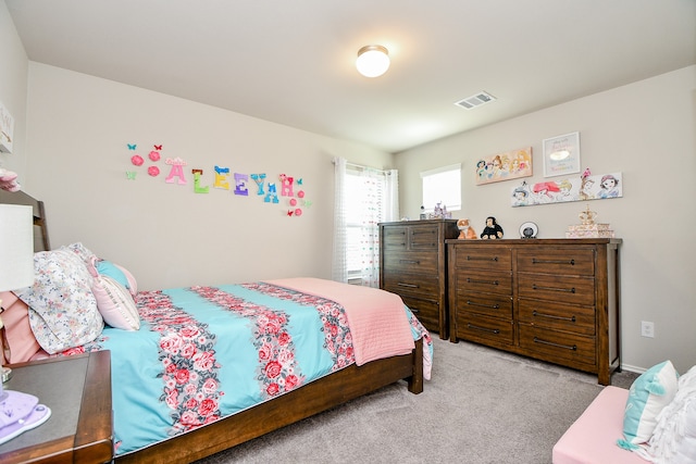 bedroom featuring light carpet