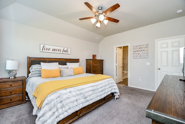 carpeted bedroom featuring ensuite bathroom, ceiling fan, and vaulted ceiling