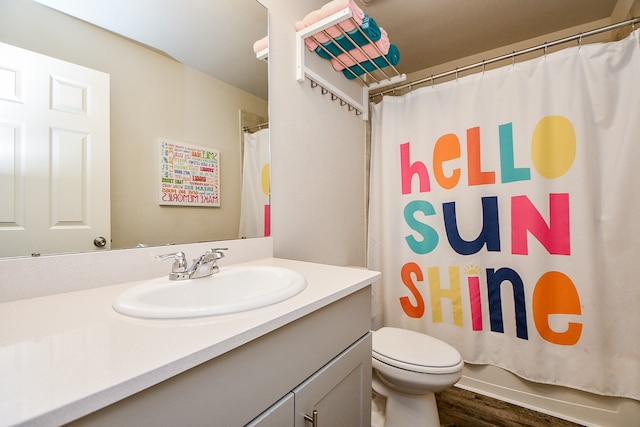 bathroom featuring hardwood / wood-style floors, vanity, toilet, and a shower with curtain