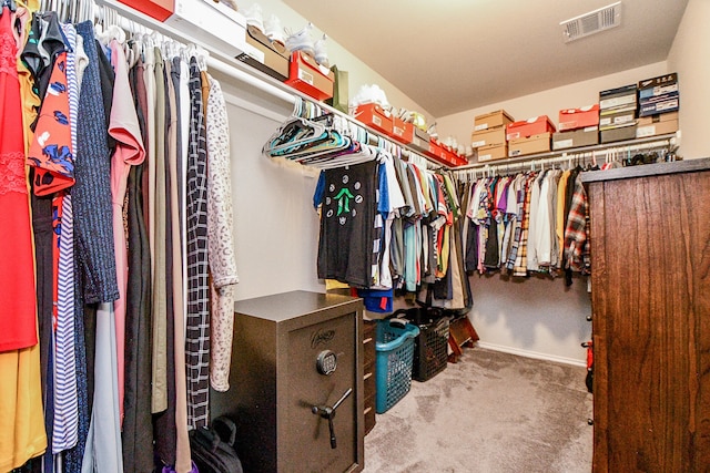 walk in closet with carpet floors