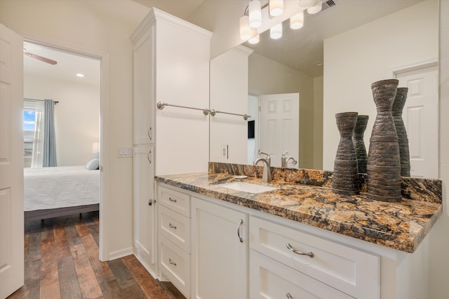 bathroom featuring hardwood / wood-style flooring, ceiling fan, vanity, and vaulted ceiling