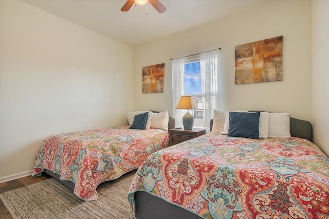 bedroom featuring ceiling fan and dark wood-type flooring