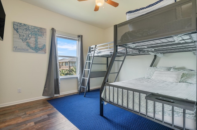 bedroom with dark hardwood / wood-style floors and ceiling fan