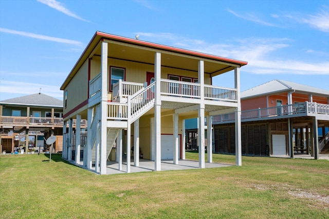 back of house with a patio area and a yard