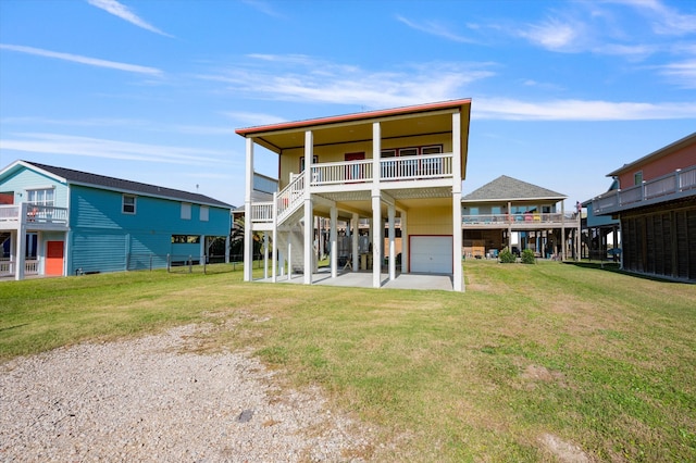 rear view of property with a yard and a garage