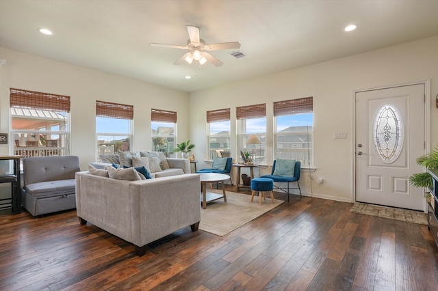 living room featuring ceiling fan, a healthy amount of sunlight, and dark hardwood / wood-style flooring