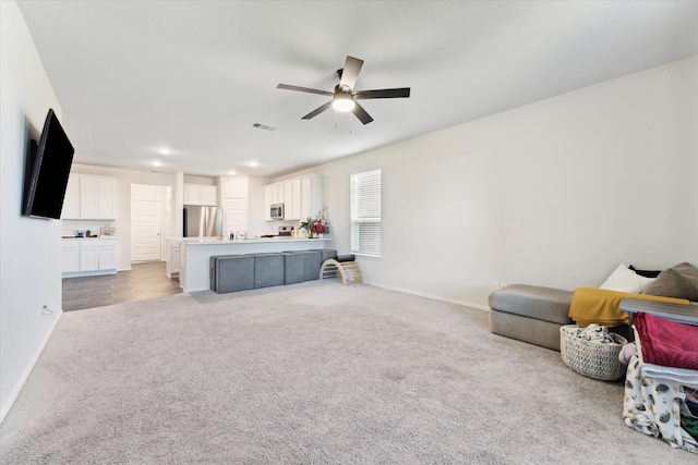 living room with ceiling fan and light carpet