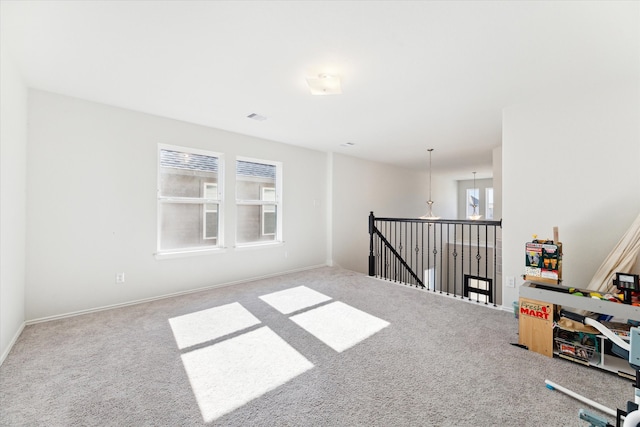 carpeted spare room featuring a healthy amount of sunlight