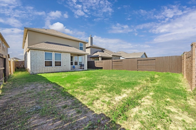 back of house featuring a yard