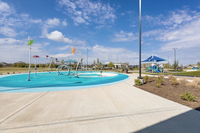 view of pool with a playground