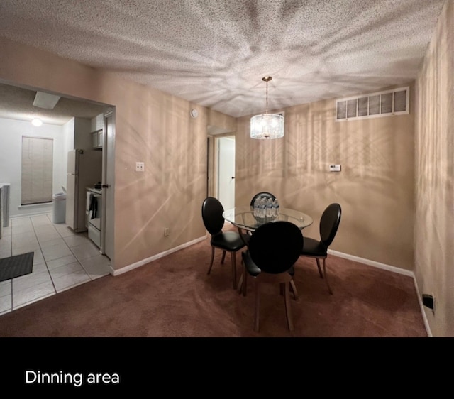 unfurnished dining area featuring a textured ceiling, light colored carpet, and an inviting chandelier